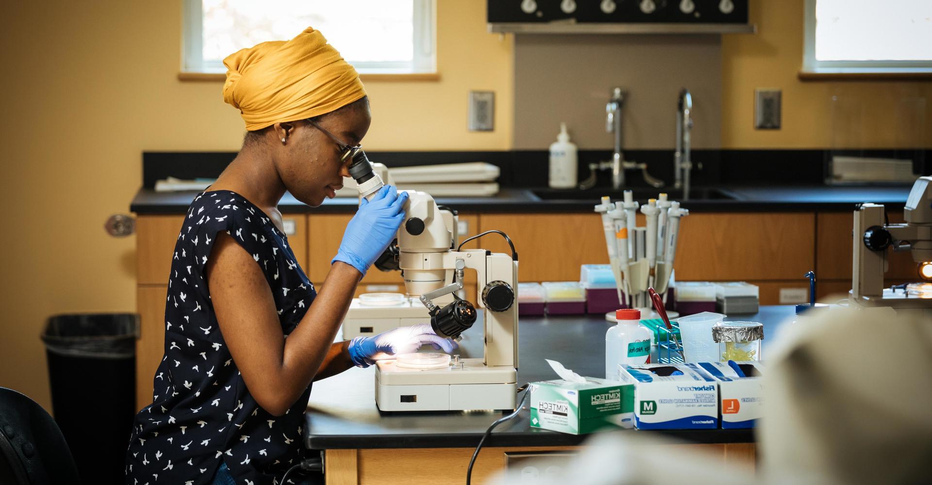 woman using a microscope